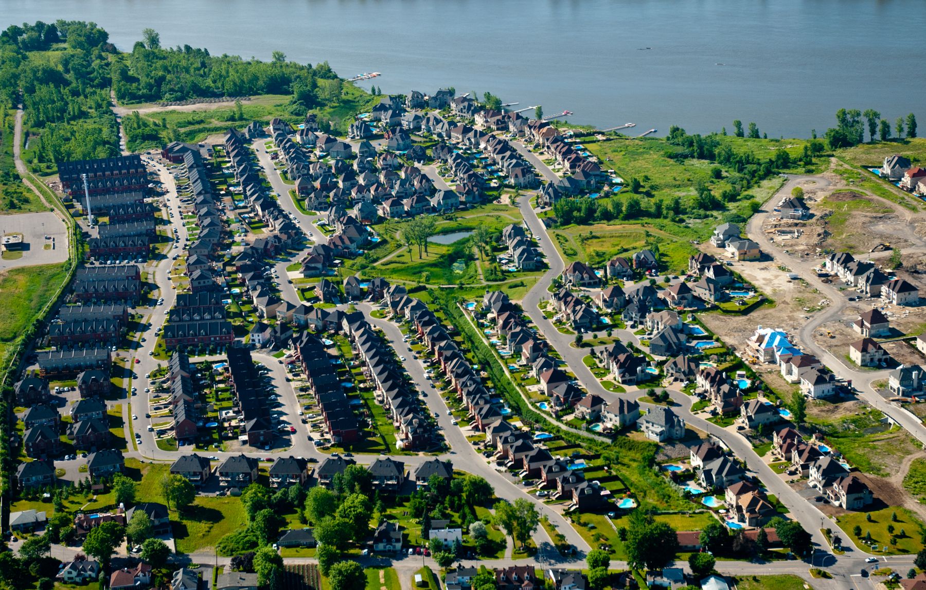 Aerial view of a completed residential development beside the water